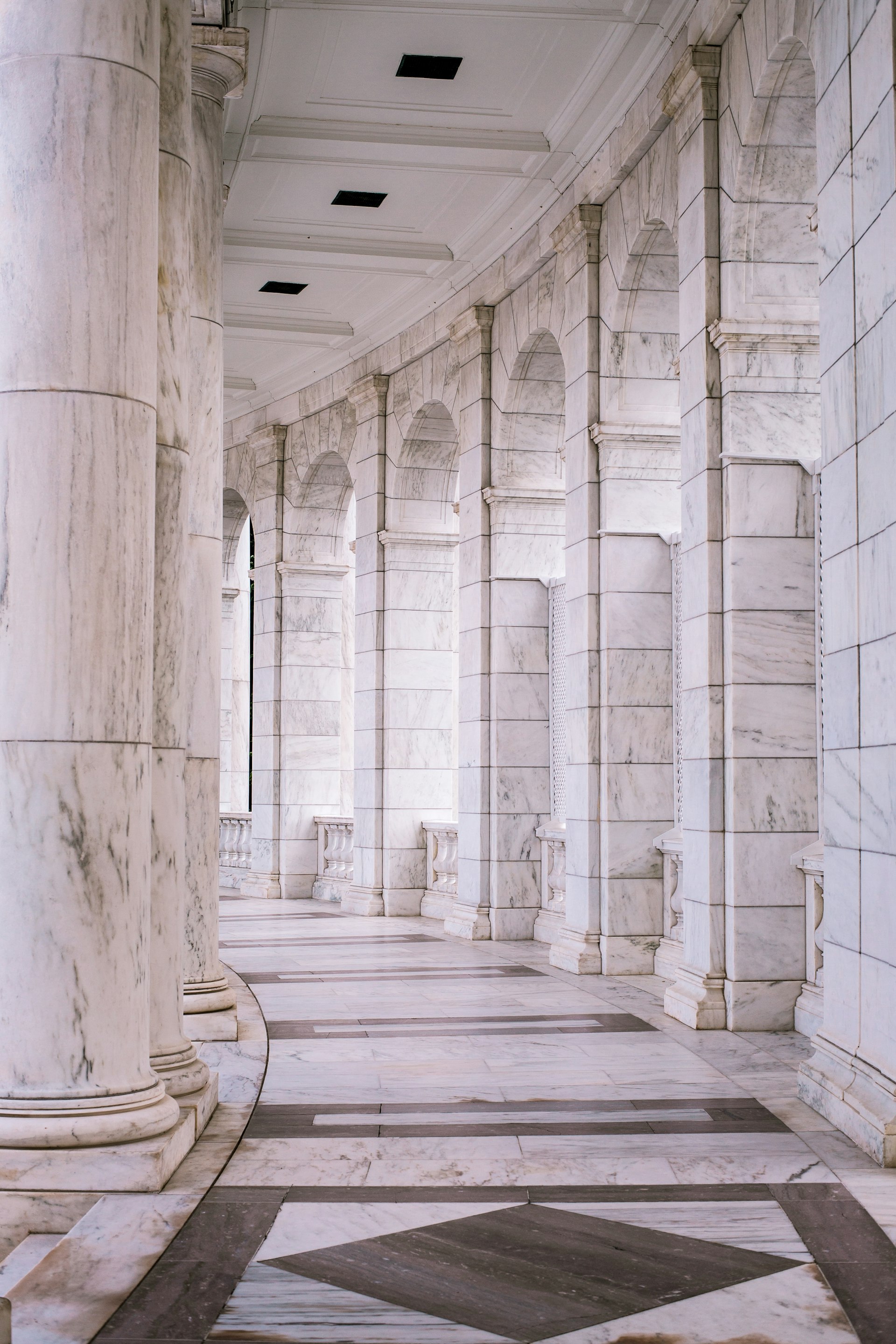 Grand carved marble hallway opening to garden