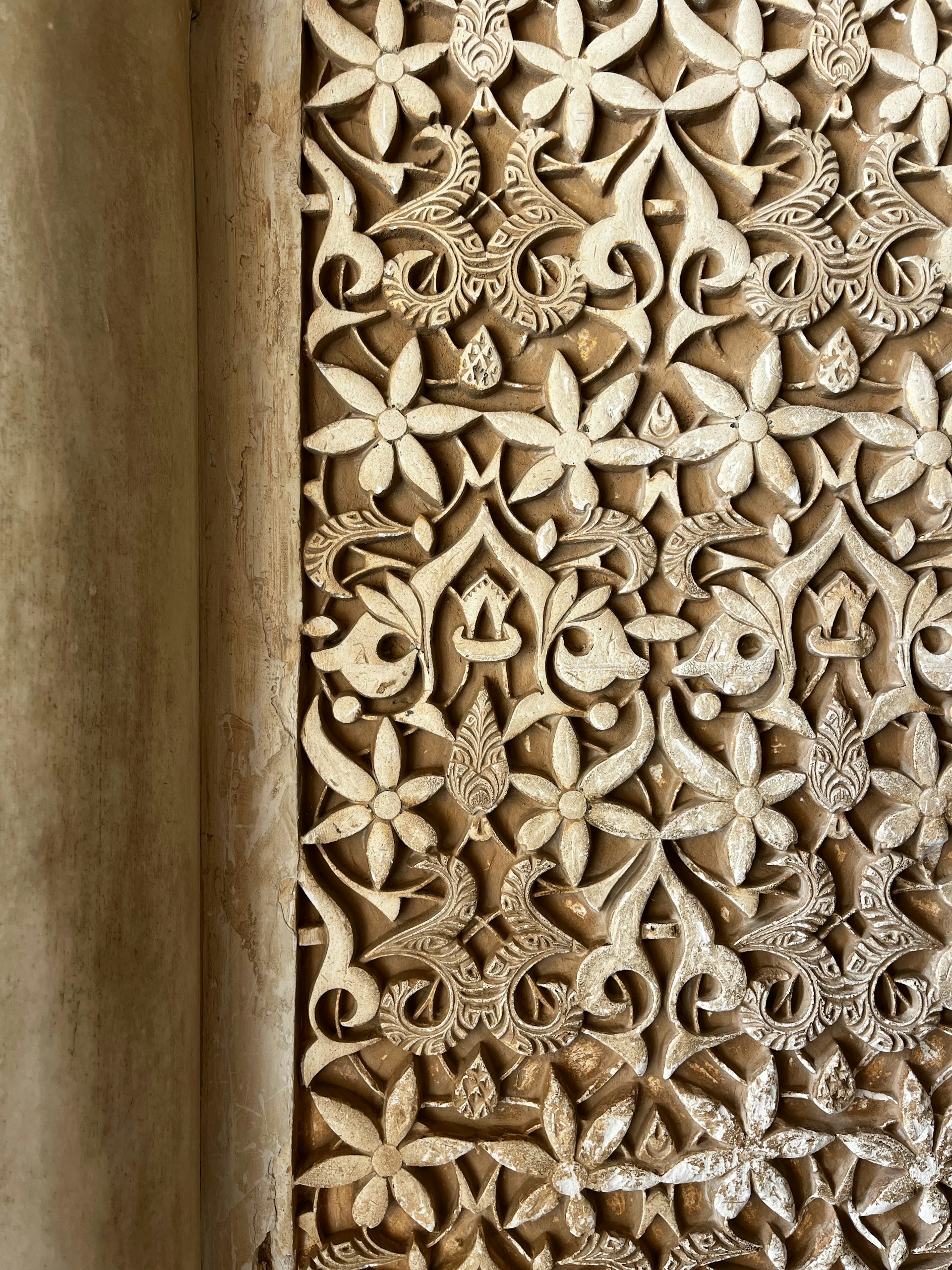 Intricate CNC-carved jaali stone screen detail