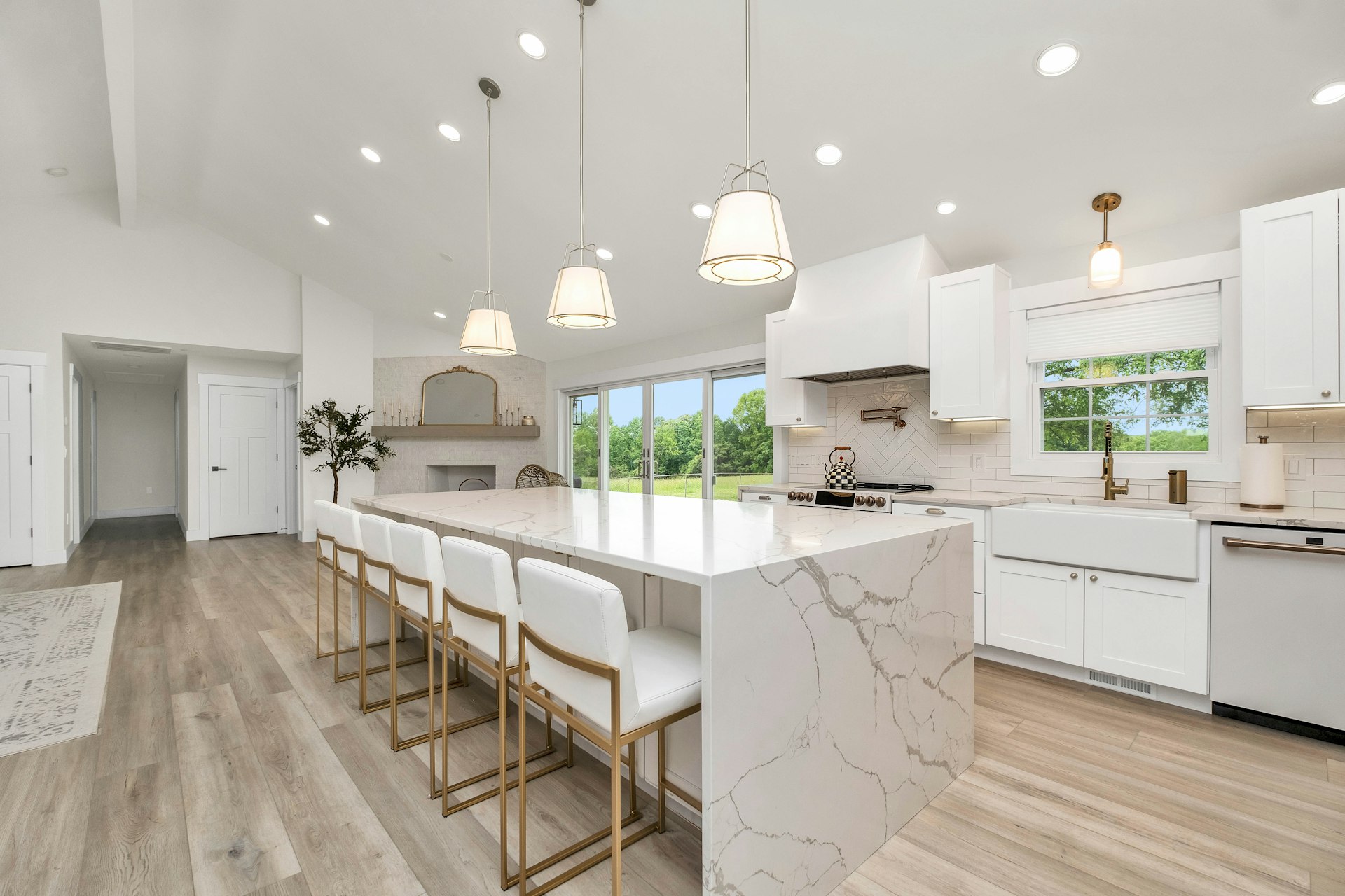 Marble waterfall island and stone mosaic backsplash kitchen