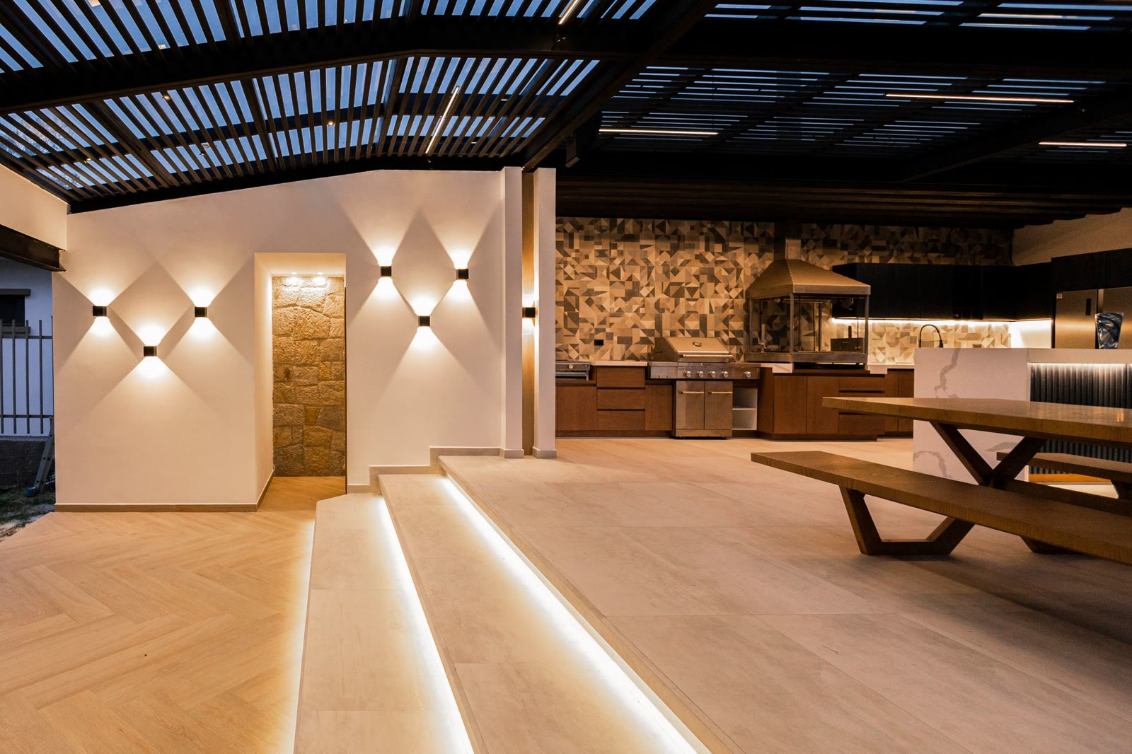 Modern outdoor kitchen with stone countertops and integrated grill