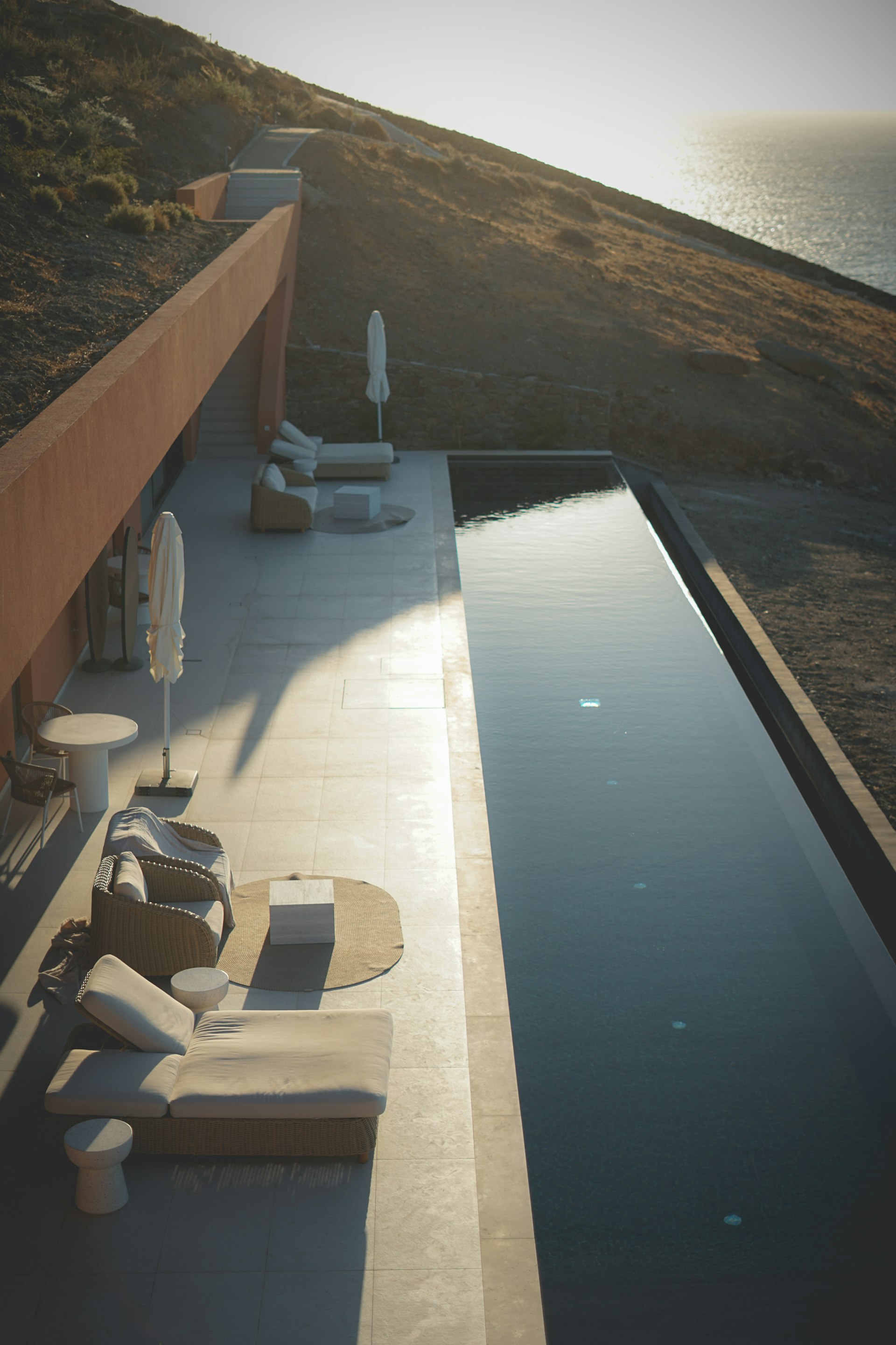 Outdoor lounge patio beside stone-clad villa