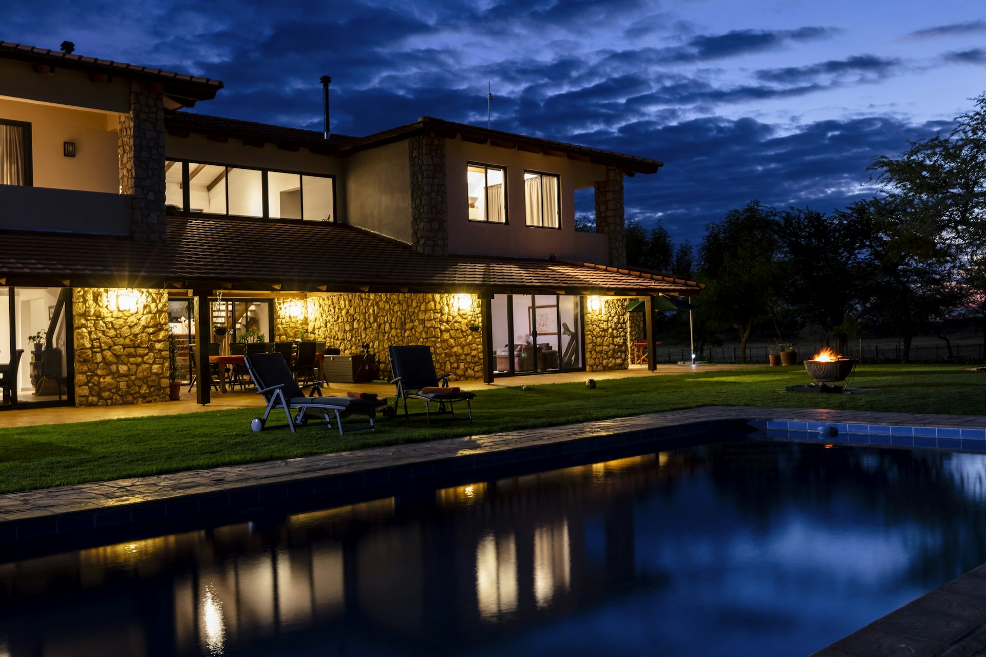 Stone-clad villa facade at dusk